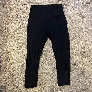 Athleta Lightning Capri in xs black with mesh panel at the bottom of legs